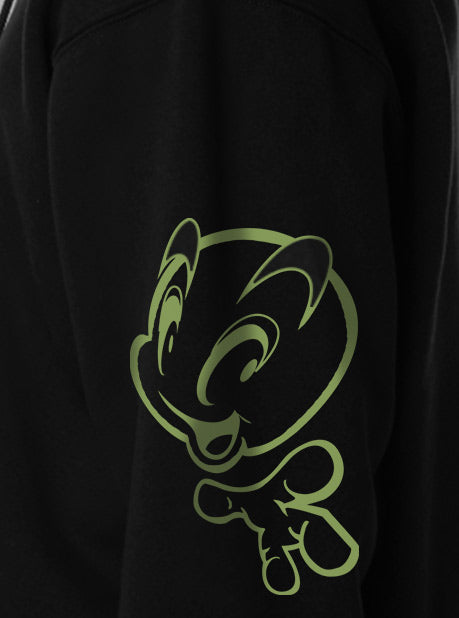 A close-up view of a black sweatshirt featuring a minimalistic green character design on the side sleeve.