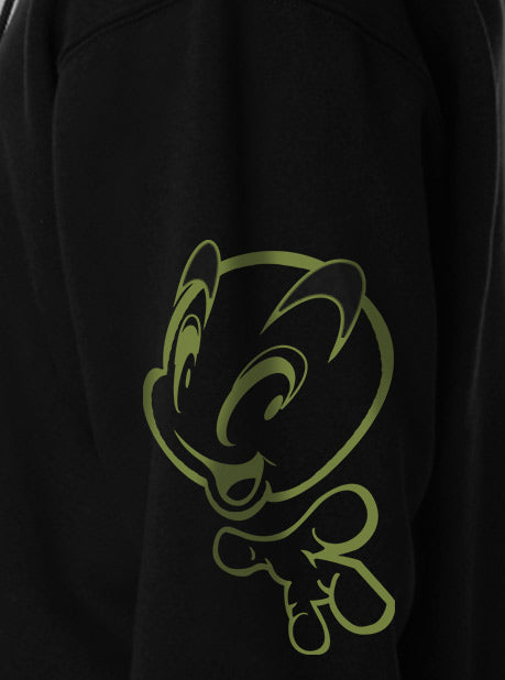 A close-up view of a black sweatshirt featuring a minimalistic green character design on the side sleeve.